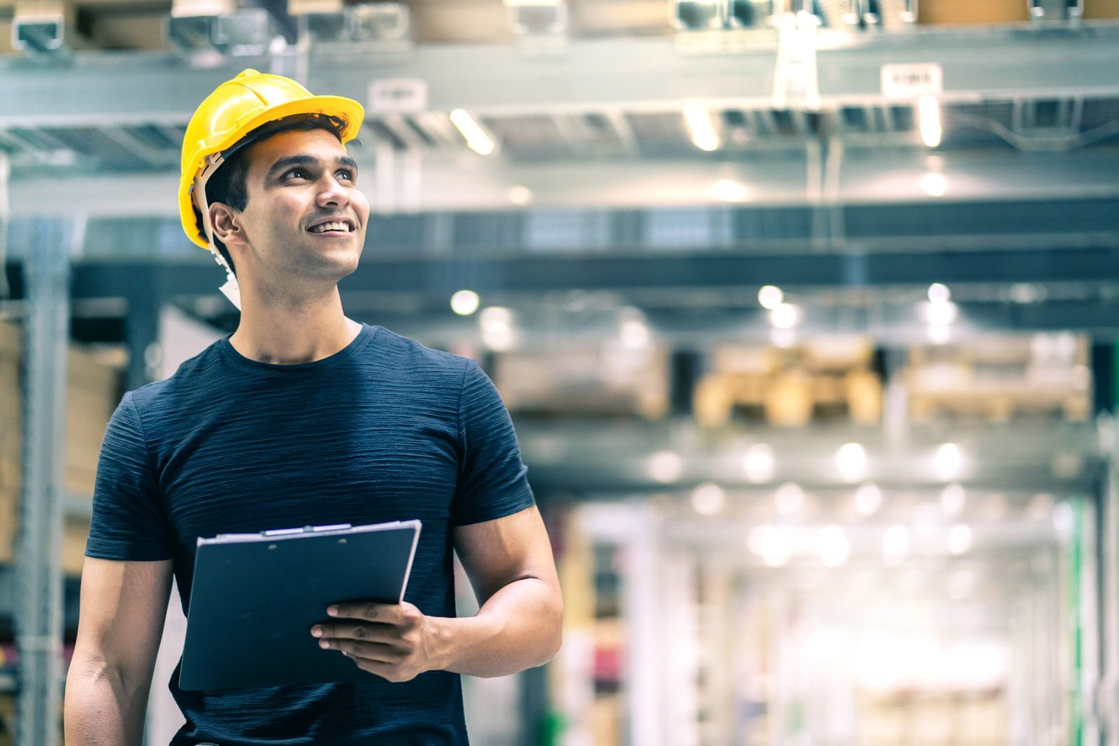 Smart Indian engineer man wearing safety helmet doing stock tick