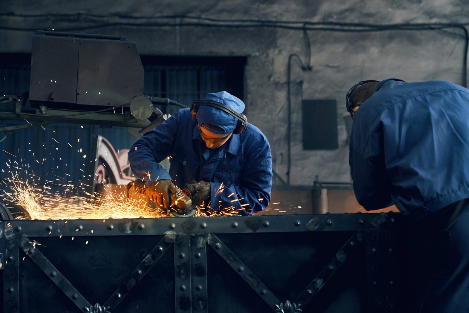 Two worker making gates in smithy.